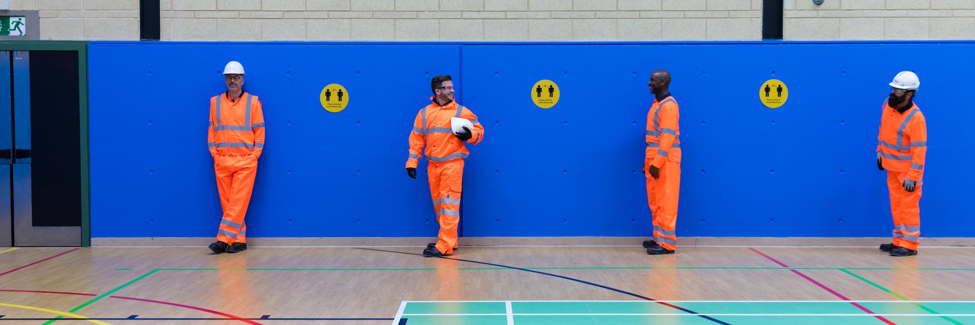 Four rail workers stood next to each other