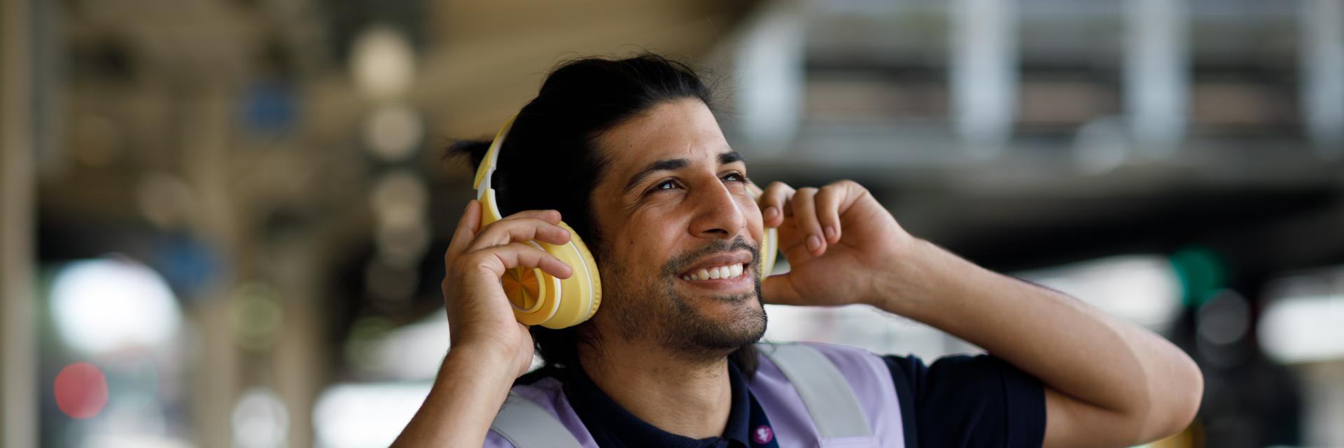 Man smiling wearing ear defenders