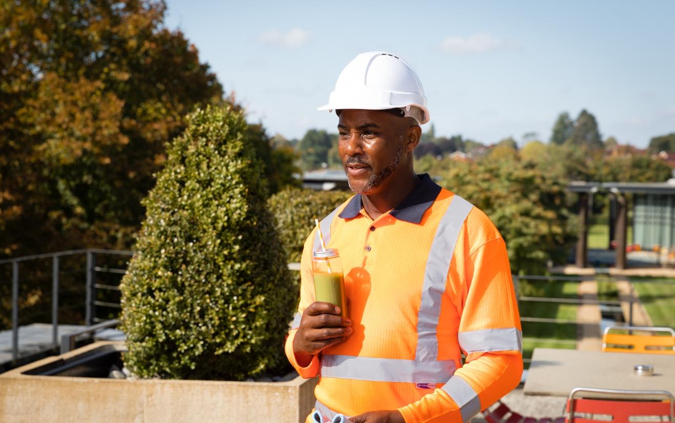 Workman holding drink in hand